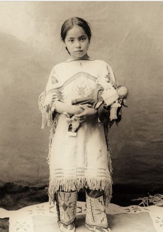 Vintage photo native americal girl with a doll.