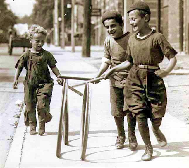 Vintage photo. Kids with retro toys - hoops.
