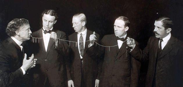 Retro photo of Harry Houdini and his trick "The East Indian Needle Trick"