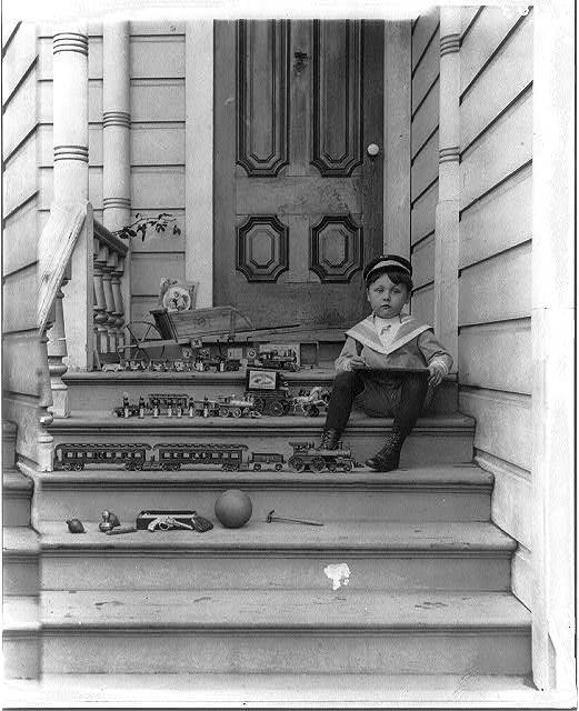 Vintage. Collection of toy trains and a boy. 1910