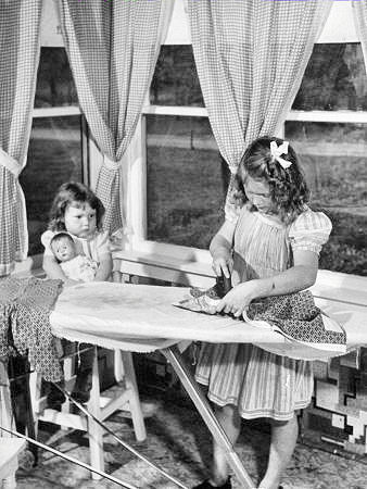 retro photo girls play with toy iron