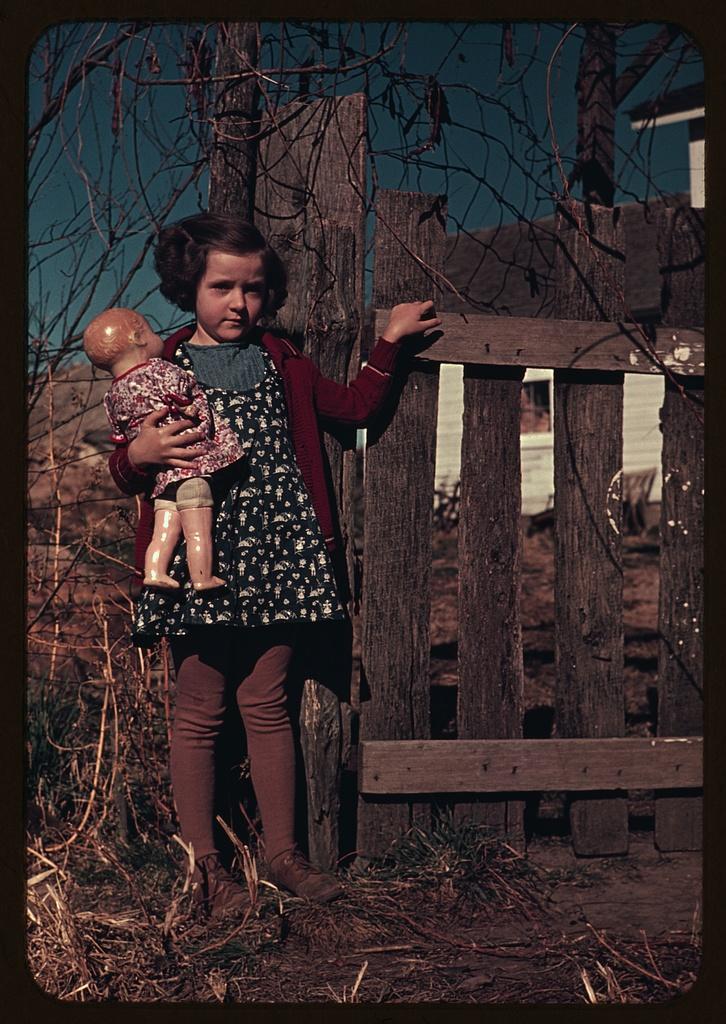 Vintage photo in colour a girl with a toy