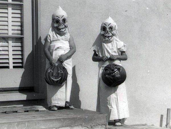 Kids in halloween homemede ghost costumes.