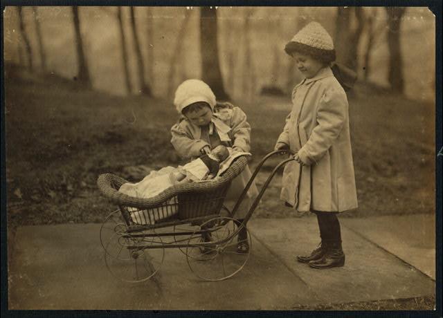 Kids playing with doll and toy stroller 1912