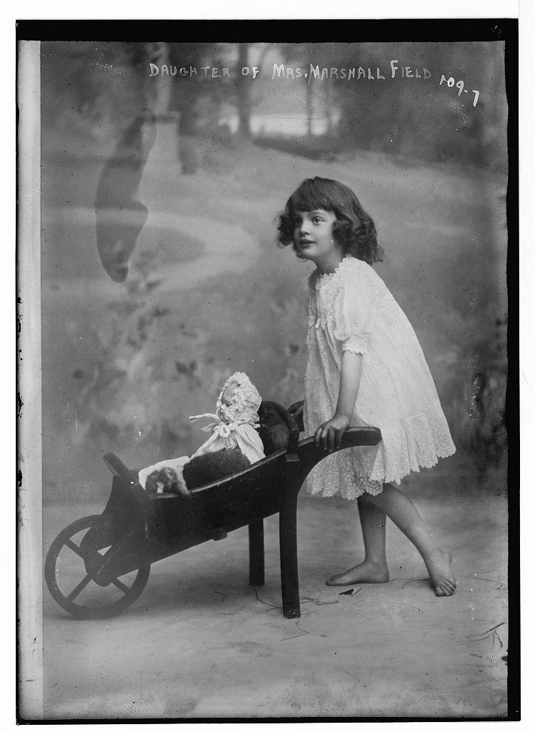 1907 a girl with a doll and a toy stroller