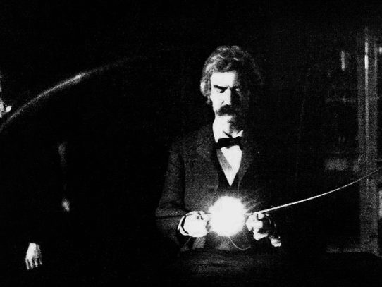 Mark Twain holding an experimental electronic lamp in Tesla’s lab, 1894