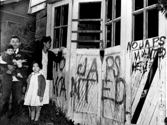 A Japanese family returning home from a relocation center camp after WWII, Seattle, 1945
