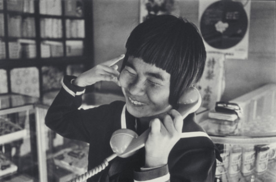 Shinobu Sakamoto talking with a friend. Photo taken by Aileen M. Smith. 1972