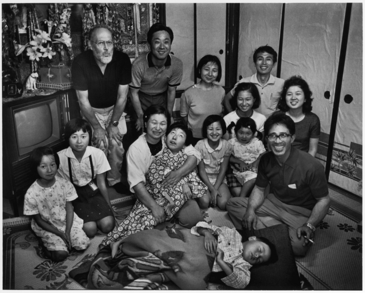 Tomoko with her family, supporters, Gene, and Asahi Camera editor, taken at Tomoko’s home in Minamata on her sixteenth birthday. Photo by Aileen M. Smith. June 13, 1972.