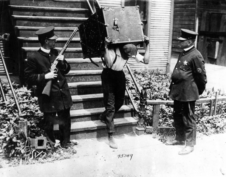 Black man carrying a safe
