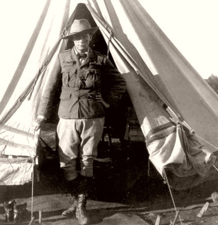 Churchill standing at the opening of his tent as a war correspondent during the Second Boer War, in Bloemfontein, South Africa, 1900.