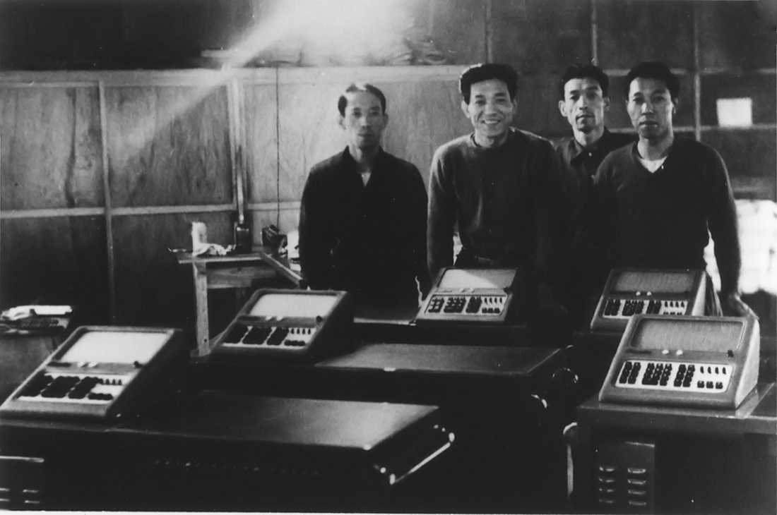 Four Kashio brothers with the first Casio calculator