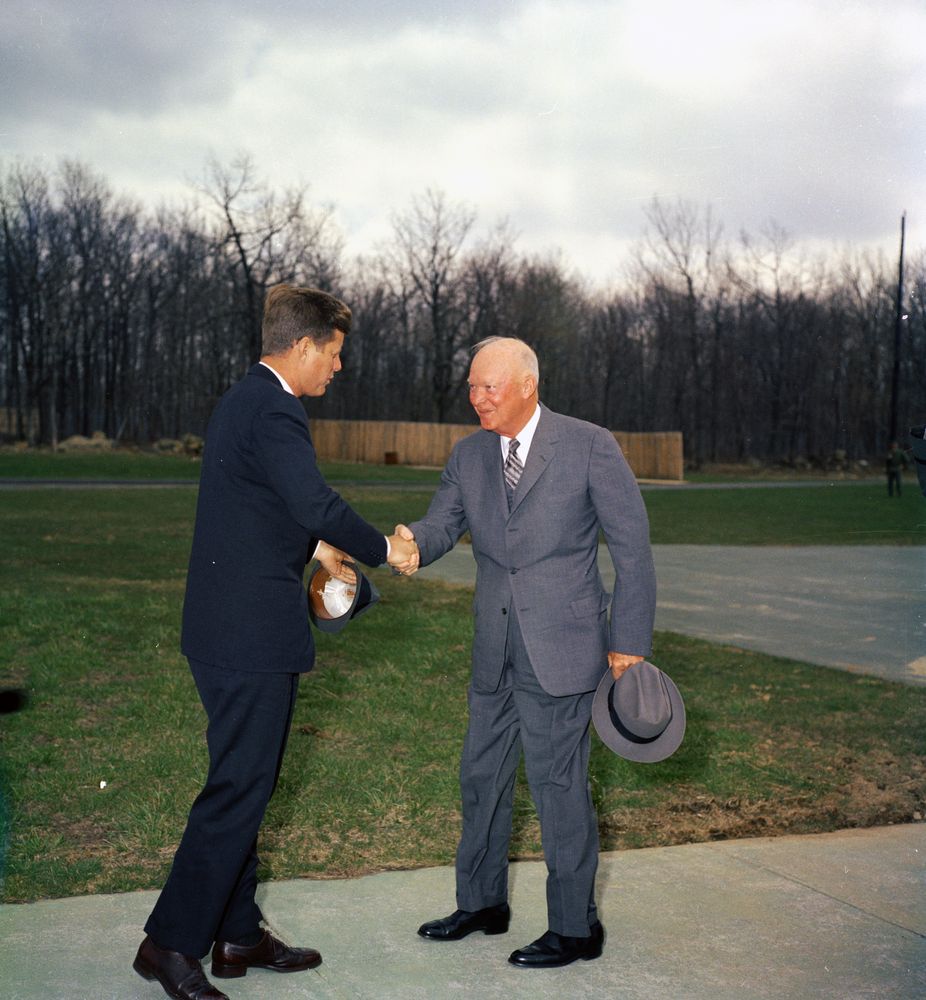 President John F. Kennedy greets former President General Dwight D. Eisenhower at Camp David