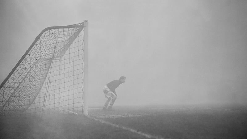 Vintage photo of football goalkeeper in the fog