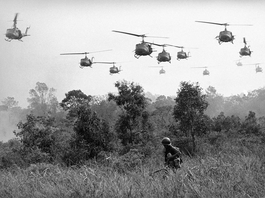 U.S. Army helicopters pour machine gun fire into the tree line to cover the advance of Vietnamese ground troops in an attack on a Viet Cong camp on March 29, 1965.